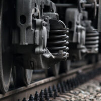 Closeup of wheel of railway car on rails.