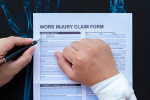 Closeup of an employee filling out a work injury report