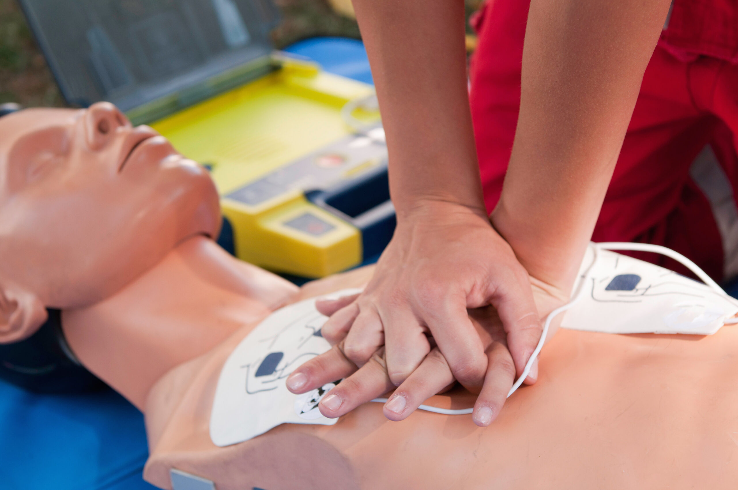 nurse applying compressions to cpr dummy