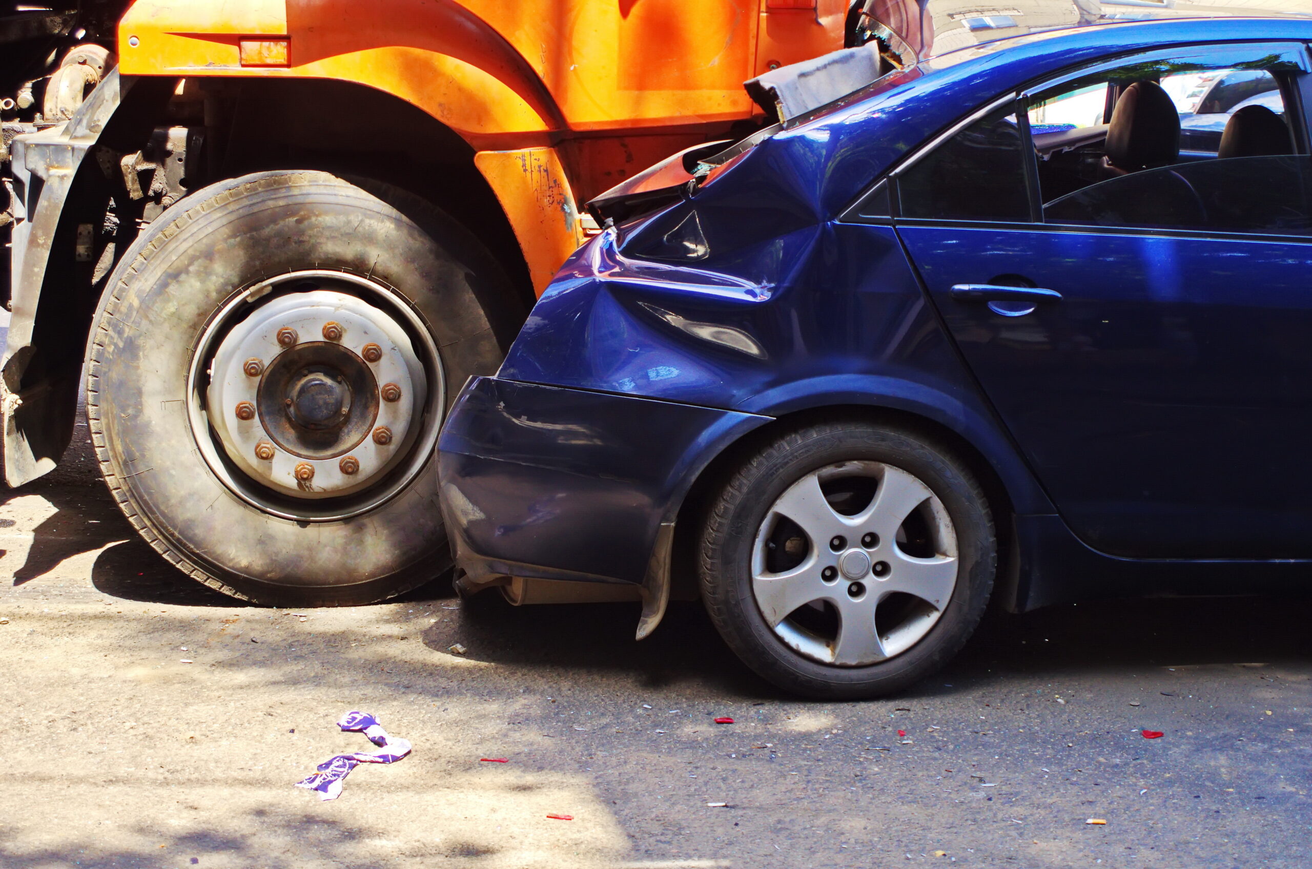 Closeup of a trucking accident between a semi-truck and a small sedan