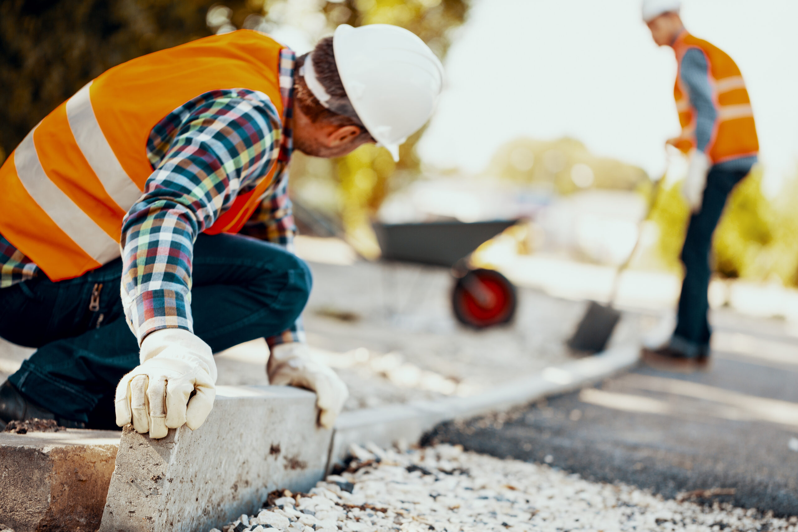 Image of workmen completing road construction on a sunny day