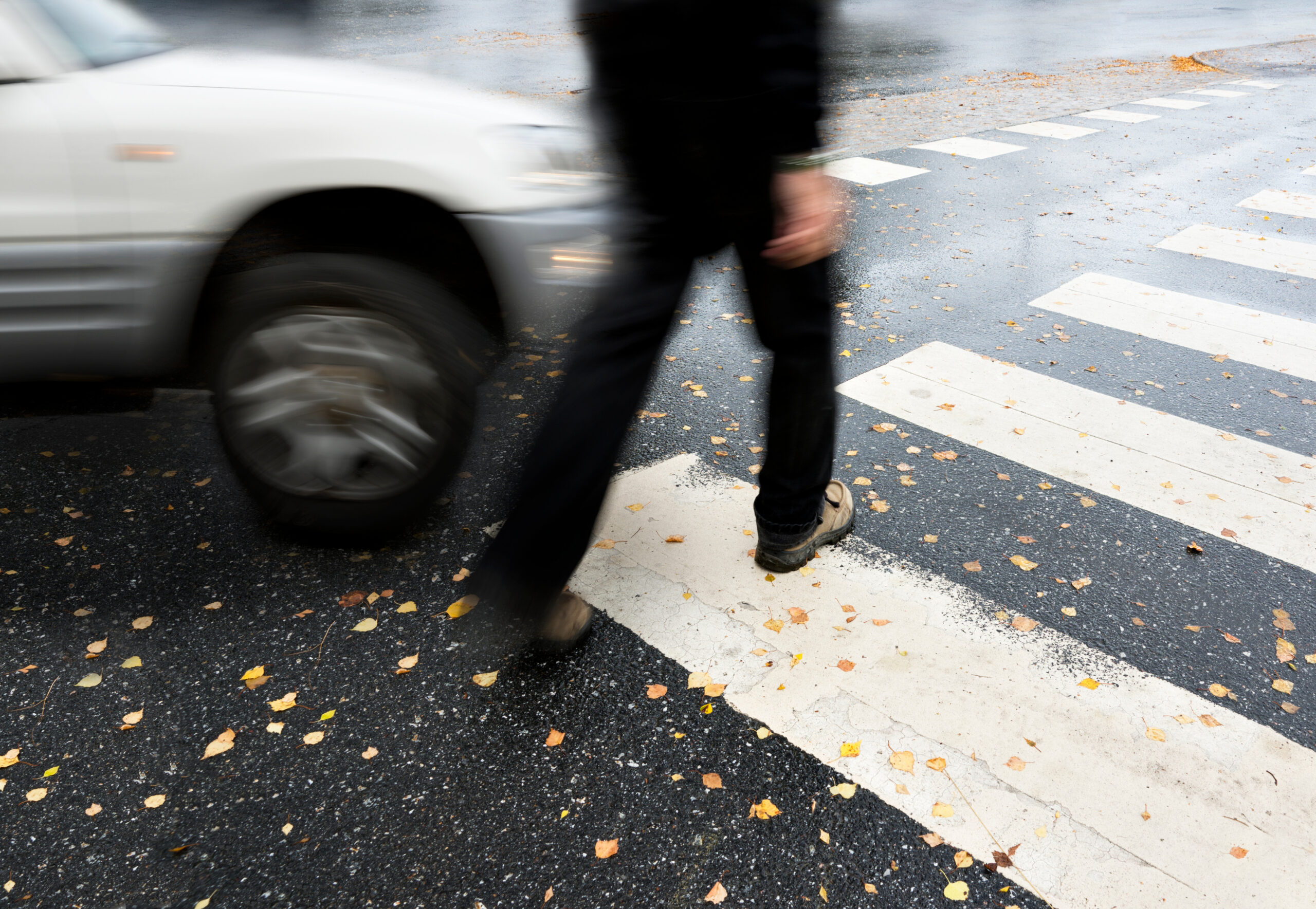Image of a car turning into a crosswalk where a pedestrian is crossing. Indicates a pedestrian accident